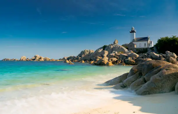 Horizontal view of the Pontusval lighthouse and bay on the north coast of Brittany in France