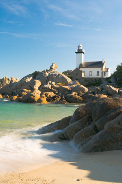 view of the Pontusval lighthouse and bay on the north coast of Brittany in France Vertical view of the Pontusval lighthouse and bay on the north coast of Brittany in France brittany france stock pictures, royalty-free photos & images