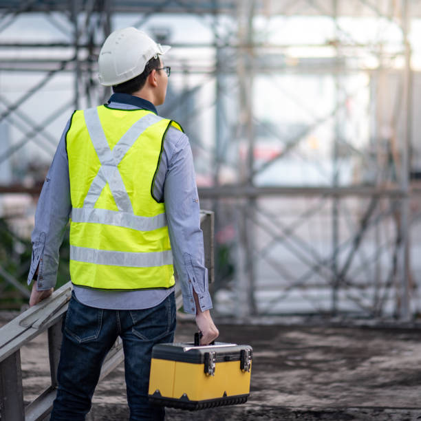 istock Worker man carrying aluminium ladder and tool box 1173110783