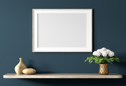 Blank canvas poster above wooden shelf with bouquet of flowers over blue wall, interior decoration background 3d rendering