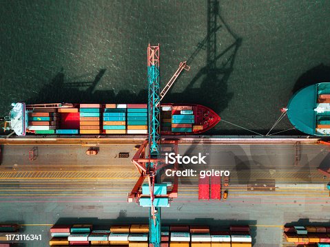 istock high angle view on Cargo crane container terminal 1173116341