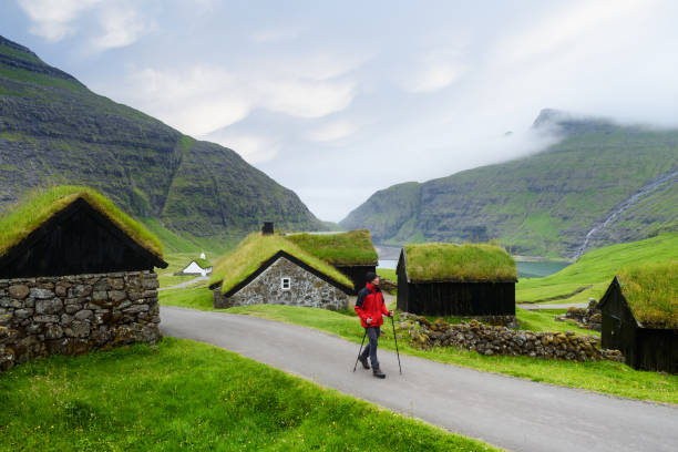 Saksun village with grass roofed houses, Faroe islands Saksun Village, Streymoy Island, Faroe islands. Old stone houses with a grass (turf) roof. Tourist sightseeing in green valley sod roof stock pictures, royalty-free photos & images