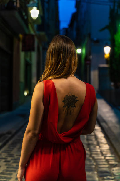 Woman with stylish tattoo on her back stock photo