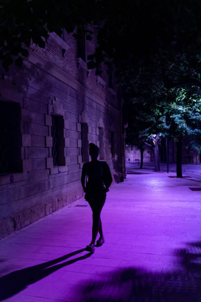 Young woman walking alone in a dark street of Vic old town stock photo