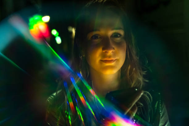 istock Beautiful young woman's portrait with rainbow light reflections 1173123504