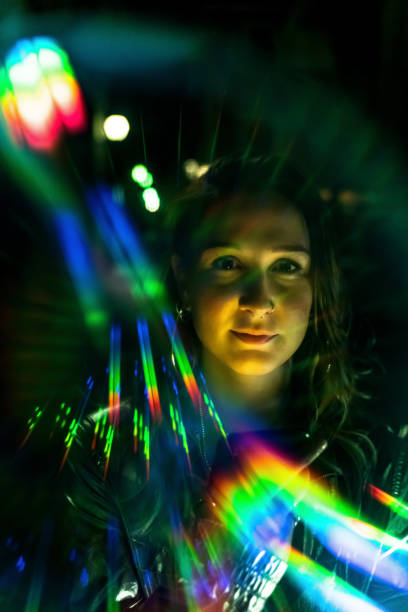 istock Beautiful young woman's portrait with rainbow light reflections 1173123506