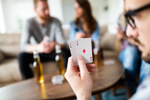 istock Two aces playing cards in male player hands 1173125152