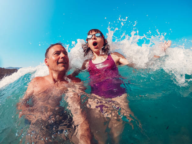istock Father and daughter having fun on the beach 1173125230