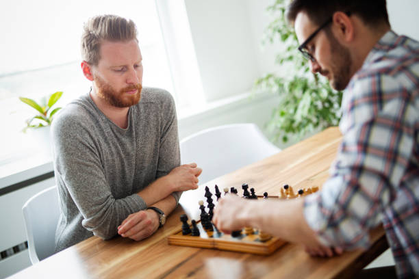 istock Portrait of two young man playing chess 1173126445