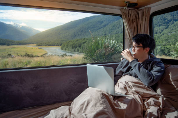 istock Asian man drinking milk in camper van 1173126719
