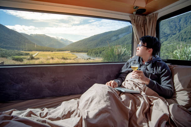 istock Asian man drinking beer in camper van 1173126737