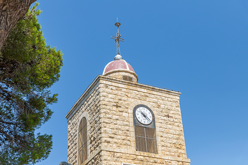 Nazareth, Israel, August 31, 2019 : Top of the clock tower of the Greek Orthodox Monastery of the Transfiguration located on Mount Tavor near Nazareth in Israel