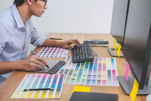 istock Image of male creative graphic designer working on color selection and drawing on graphics tablet at workplace with work tools and accessories in workspace 1173129070