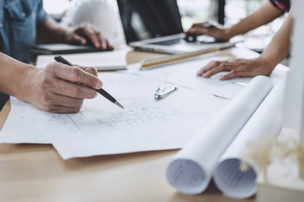 istock Construction and structure concept of Engineer or architect meeting for project working with partner and engineering tools on model building and blueprint in working site 1173129180