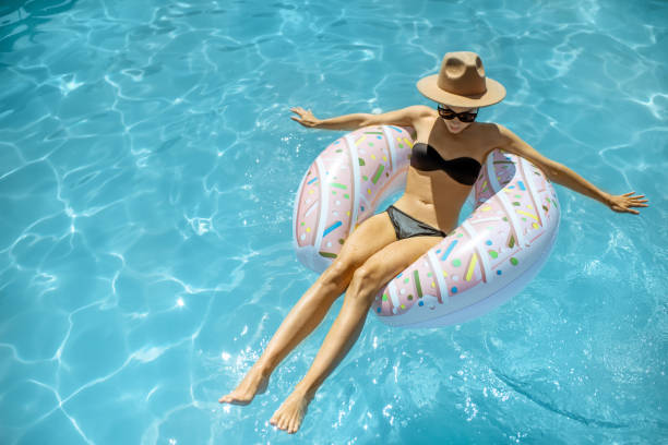 istock Woman relaxing in the swimming pool 1173129465