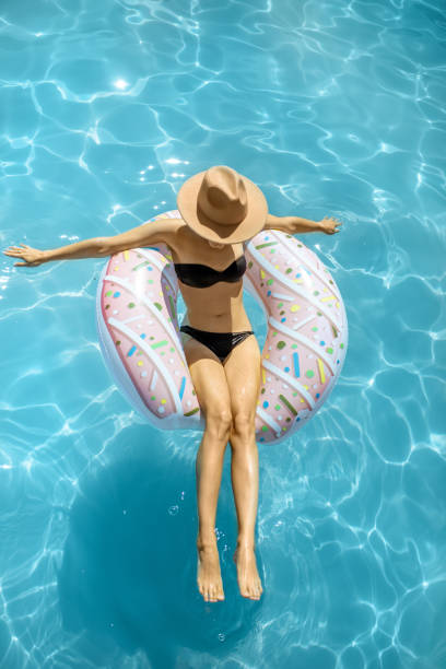 istock Woman relaxing in the swimming pool 1173129472