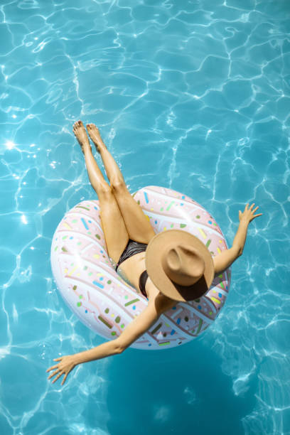 istock Woman relaxing in the swimming pool 1173129478
