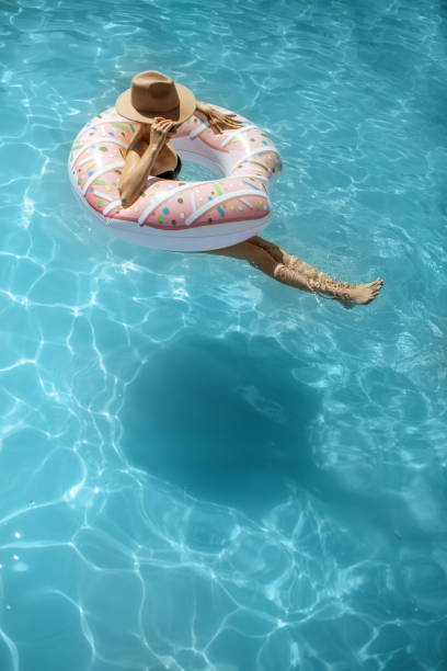 istock Woman relaxing in the swimming pool 1173129504