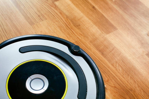 istock Vacuum Cleaning Robot on parquet floor. 1173130648