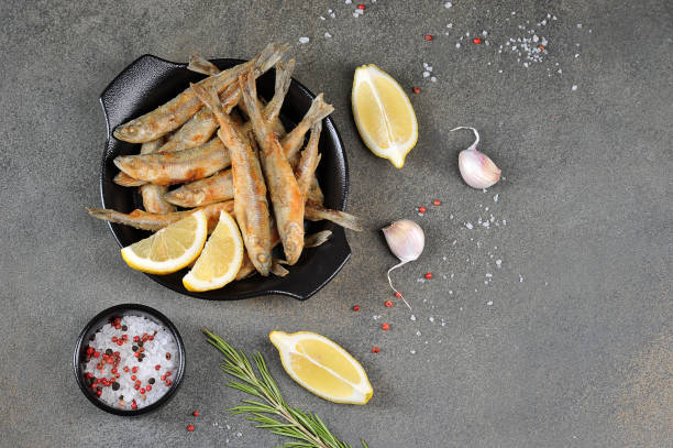 istock Fried smelt in a black pan. View from above. Free space for text. 1173133241