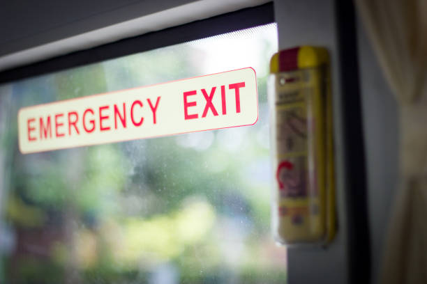 istock Emergency Exit Door Sign with Automatic Open Door Lever in the Travel Bus 1173136486