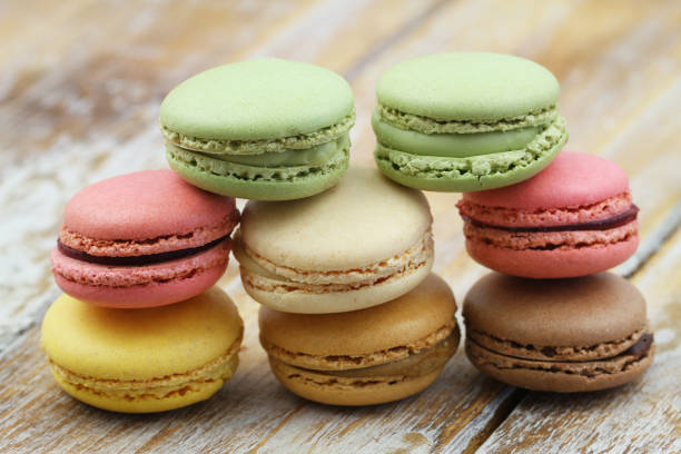 istock Stack of pistachio, chocolate and raspberry macaroons on wooden surface 1173136526