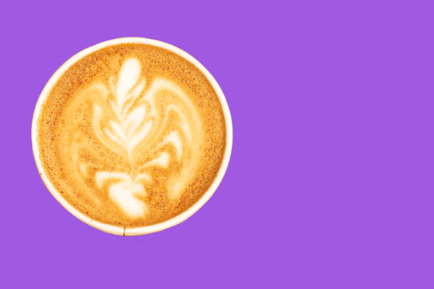 istock Coffee in a paper cup latte art on purple background. 1173140237