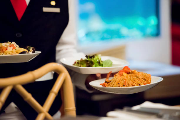 istock Waiter serving food to the customer 1173140414