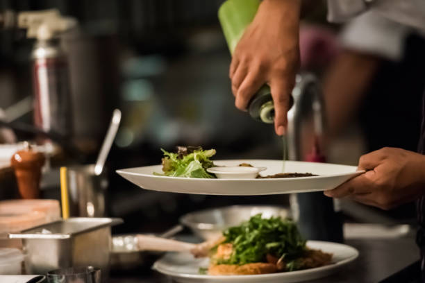 istock Chef preparing food at the kitchen 1173140632