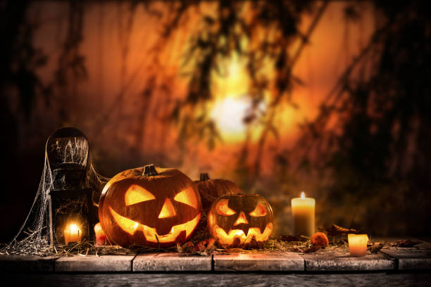 istock Halloween pumpkins on dark spooky forest. 1173140670