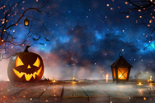 istock Halloween pumpkins on dark spooky forest. 1173141119