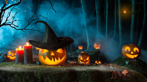 istock Halloween pumpkins on dark spooky forest. 1173141224