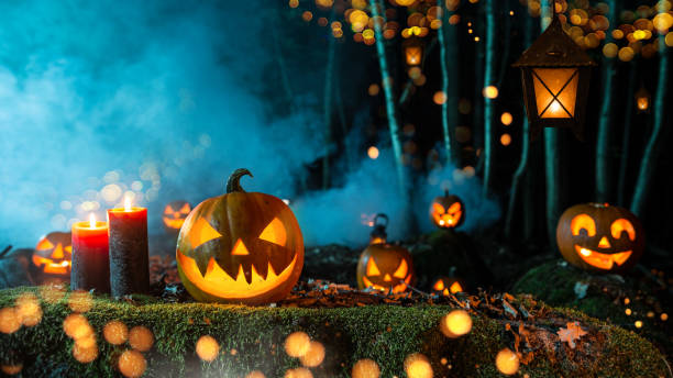 istock Halloween pumpkins on dark spooky forest. 1173141234