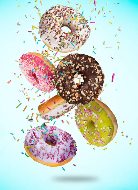 istock Tasty doughnuts in motion falling on pastel blue background. 1173141344