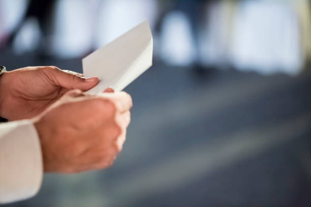 istock Man in shirt holding envelope on the stage 1173143681