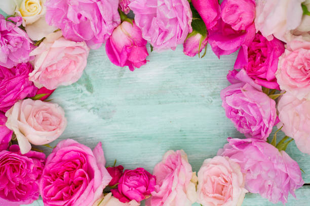 istock beautiful garden roses on turquoise wooden surface 1173149374