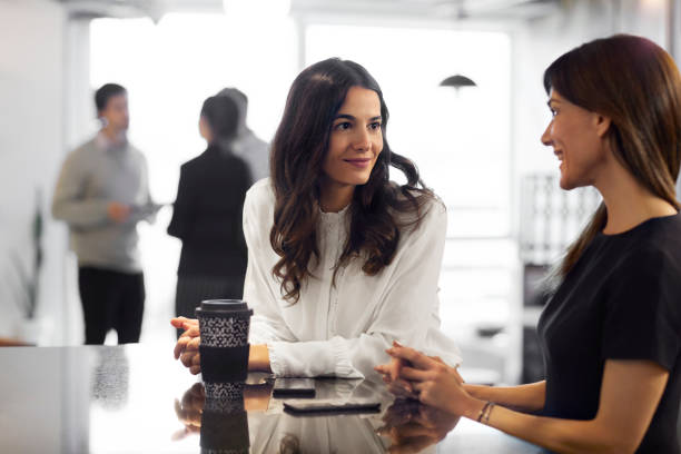 istock Female colleagues discussing during coffee break 1173150755