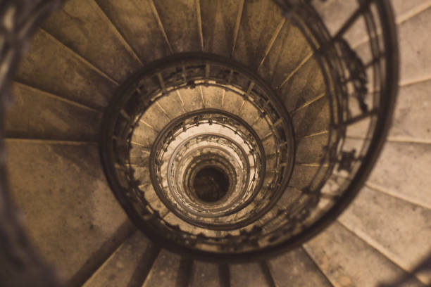 istock Winding and spiralling concrete staircase in a tower, with infinity point 1173152686