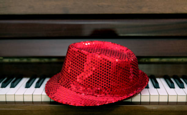 istock A red paillette hat is left on the keyboard of a classical piano 1173153045