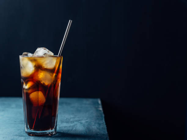 istock Cold brew coffee in a glass with metal straw on a dark background. 1173153083