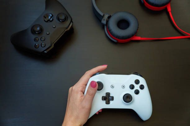 istock Woman hand holding white joystick isolated on black background 1173154146