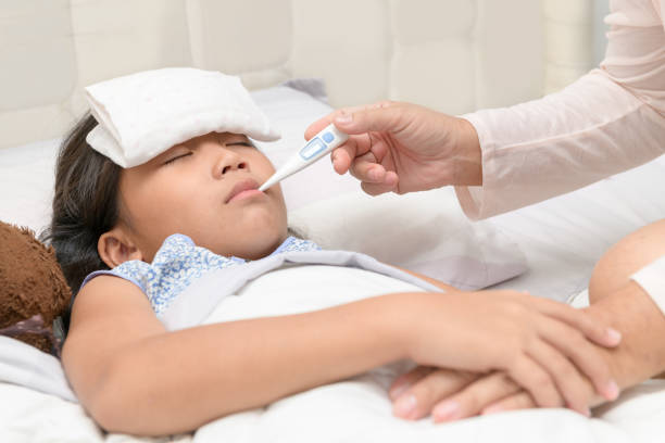 istock Mother checking temperature of her sick daughter. 1173155377