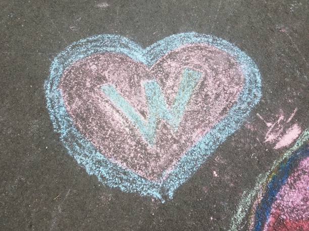 istock a blue and red heart with the letter W made from chalk 1173155547