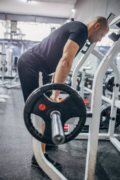 istock Strong man lifting weights at the gym 1173156007