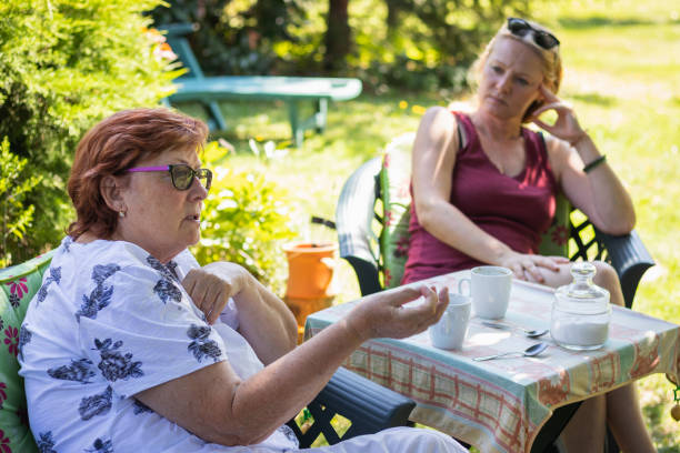 Happy Women Laughing And Hugging Friend At Cozy Outdoor Coffee Shop Seating
