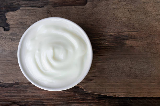 istock Yogurt  In white glass wood background from top view. 1173159461