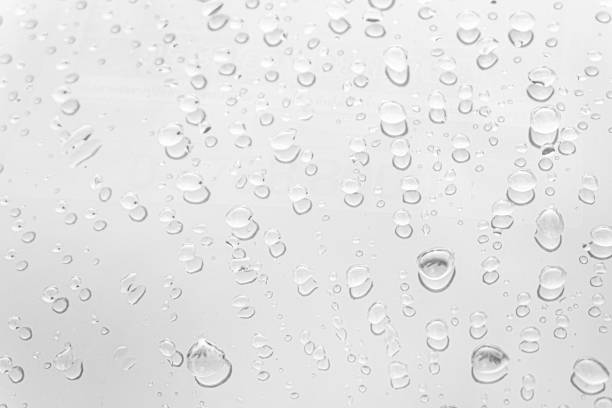 istock Water drops on glass white gray background. 1173159618