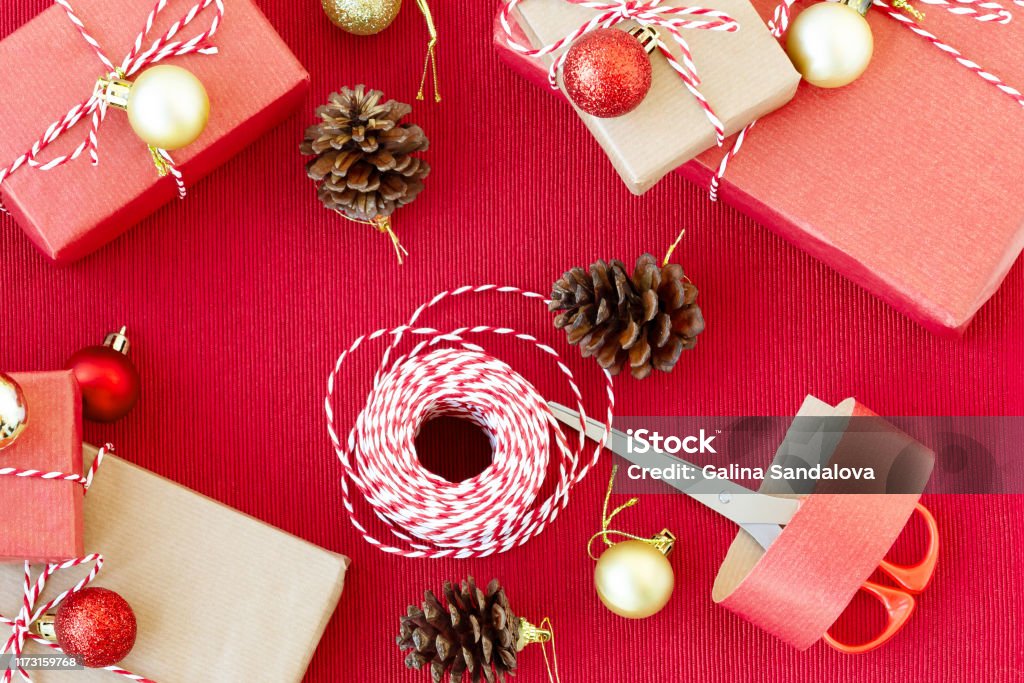 Preparing For The Holiday Gift Wrapping In Red And Beige Wrapping Paper  Stock Photo - Download Image Now - iStock