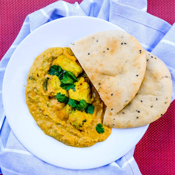 istock Indian Chicken Korma Curry Meal With Naan Bread 1173160087