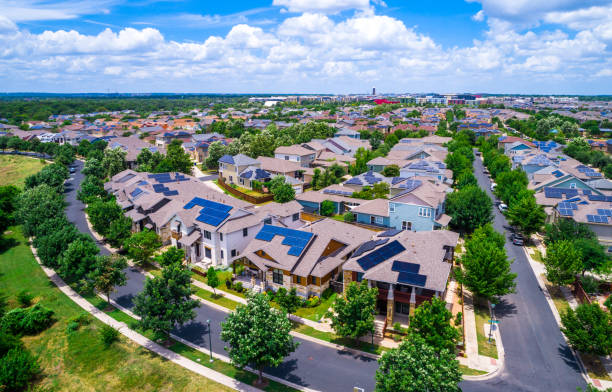 Solar Panel rooftops all over this renewable Community in Austin Texas Solar Panel Community in Austin Texas Aerial drone view above Mueller District suburb neighborhood in East Austin - Mueller District Homes And Houses with green landscape austin texas photos stock pictures, royalty-free photos & images